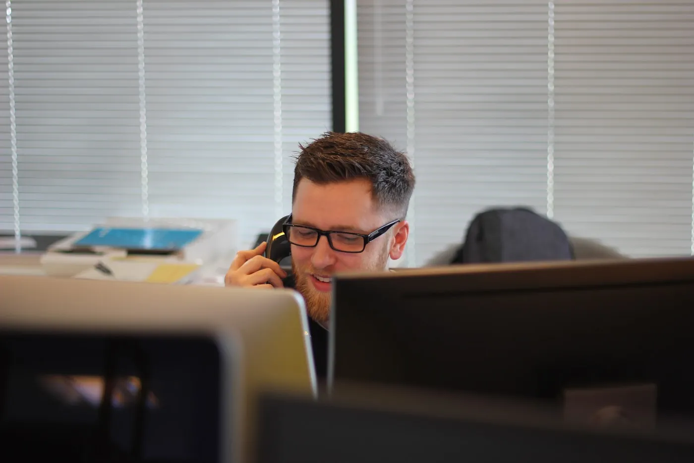 Business professional using a desk phone